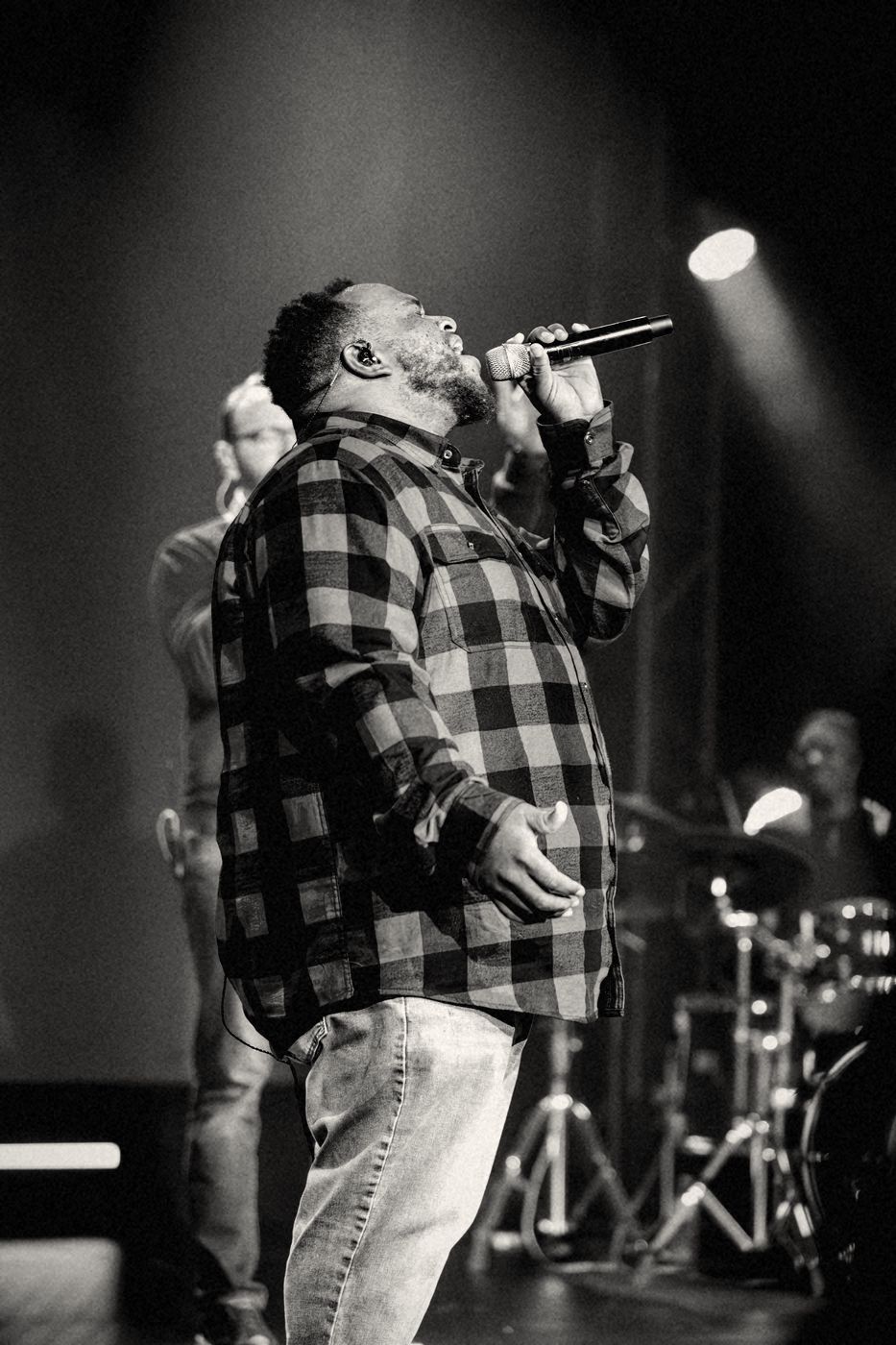 A worship leader singing on the Real Life stage